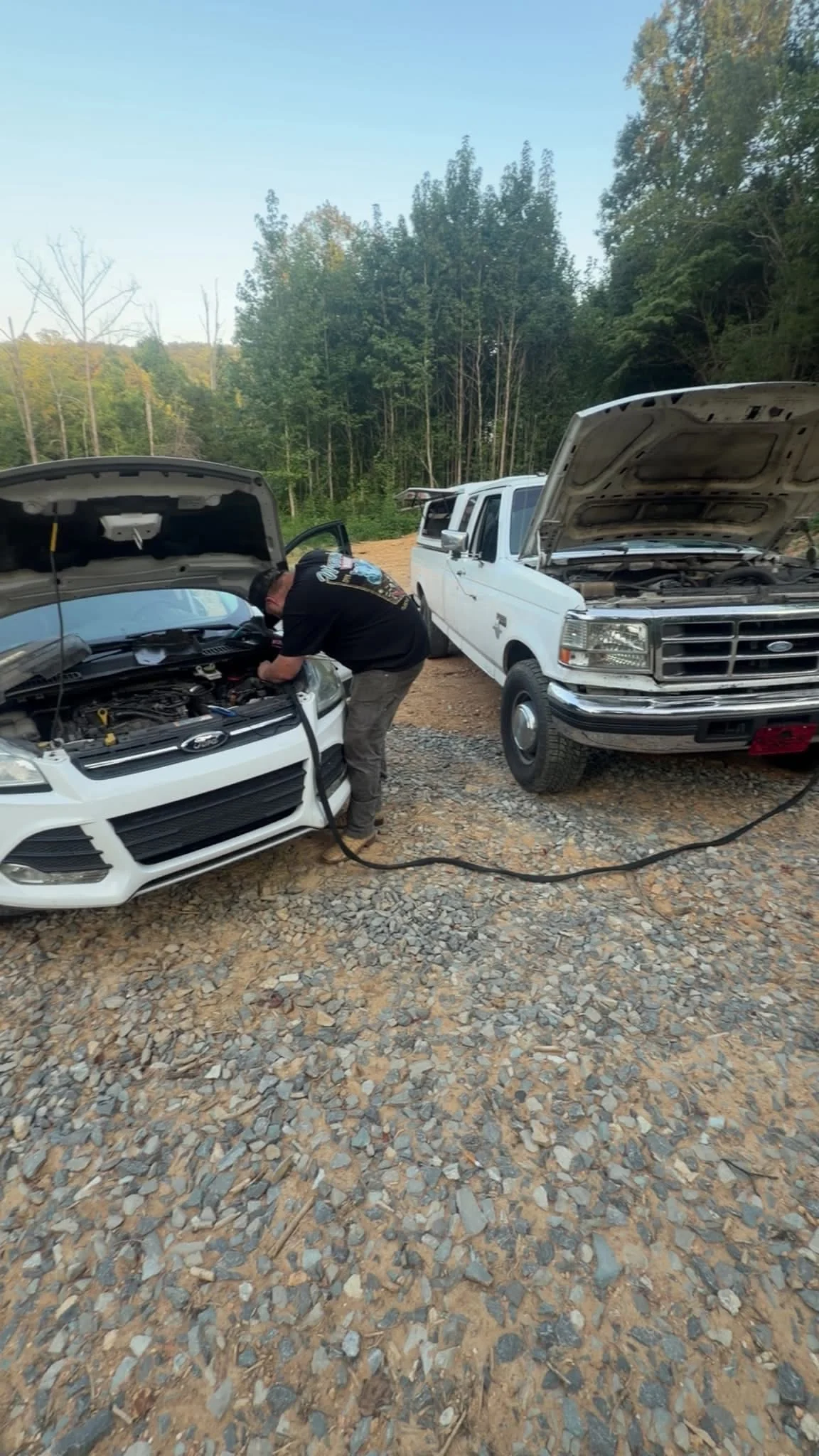 Backroad mobile mechanic working under the hood beside a service truck